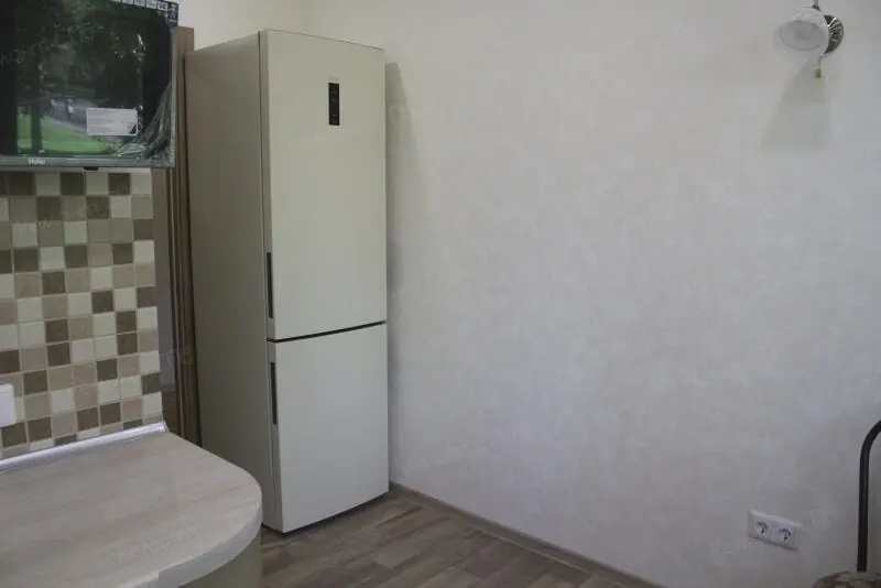 фото капитального ремонта квартиры на ул. Кустодиева д.12 установка техники на кухне